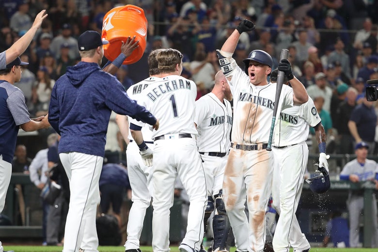 SEATTLE, WA - AUGUST 18: Kyle Seager #15 of the Seattle Mariners (R) celebrates with teammates after a balk by Dylan Floro #51 of the Los Angeles Dodgers in the tenth inning to win the game 5-4 during their game at Safeco Field on August 18, 2018 in Seattle, Washington. (Photo by Abbie Parr/Getty Images)
